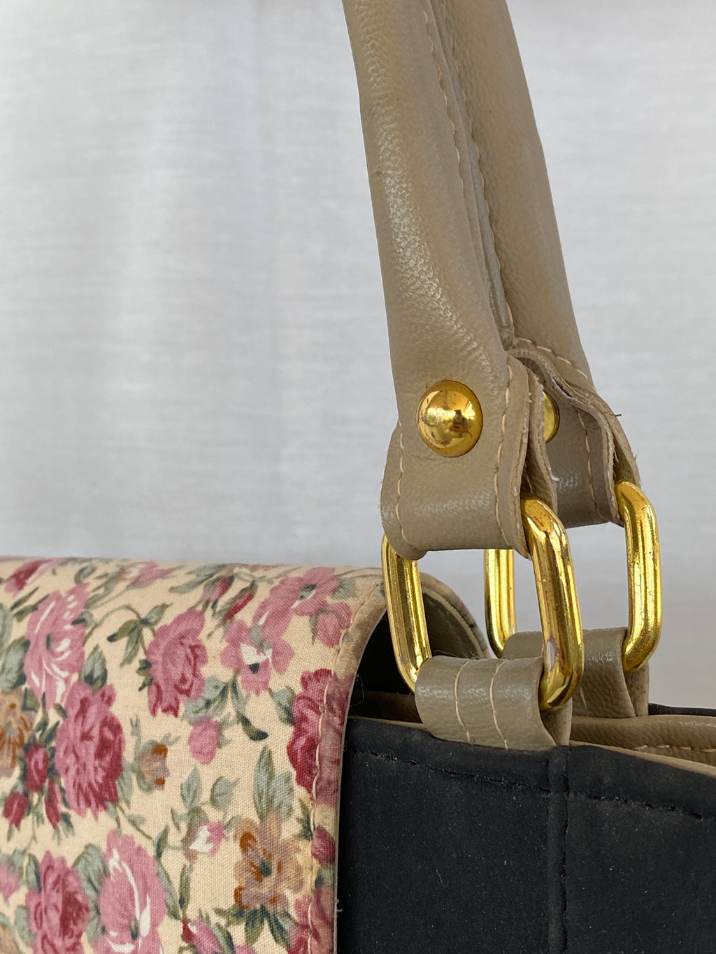 حقيبة يد من القماش الأسود ومقابض جلدية بيج وإغلاق مزهر